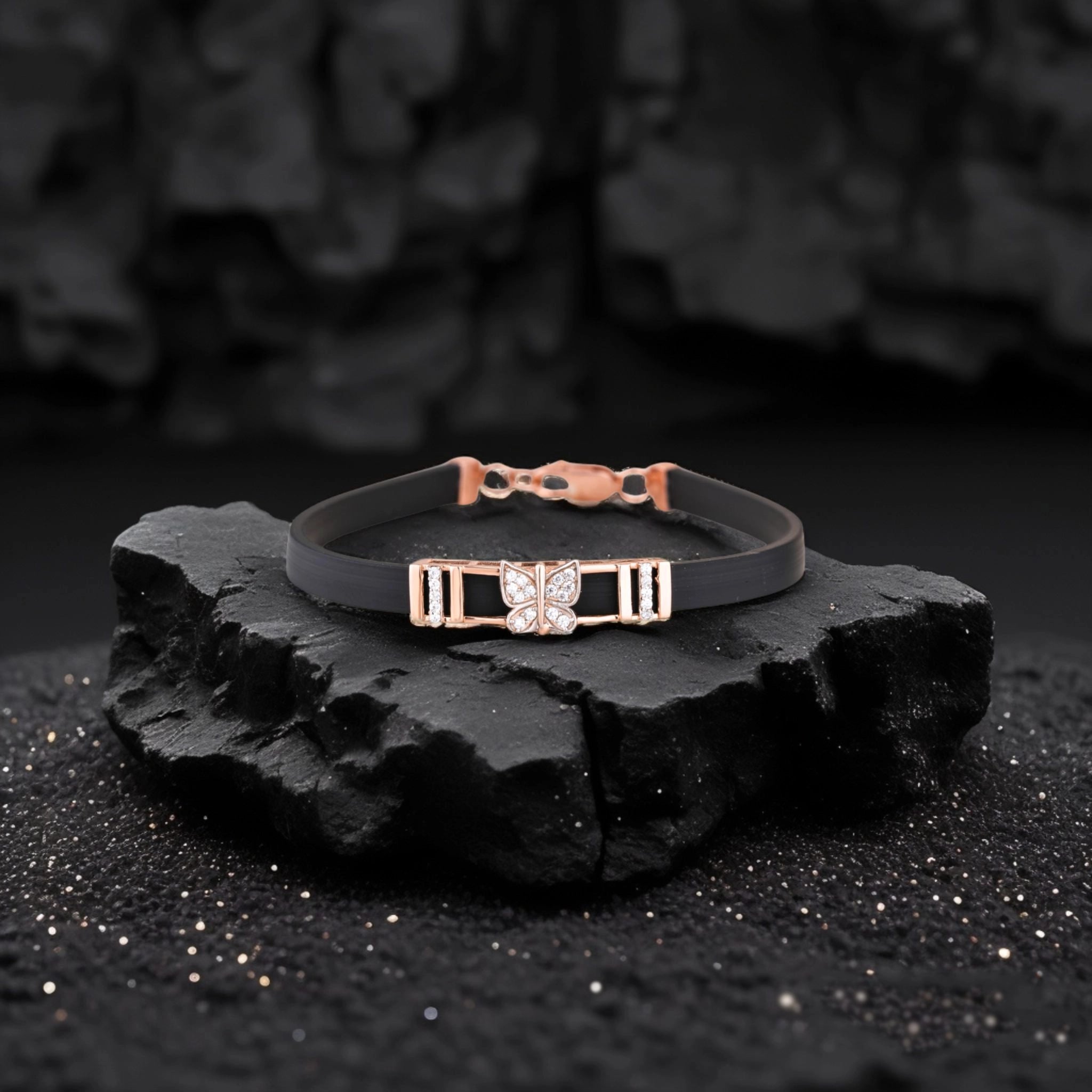 Two bracelets on a black stone surface with a dark background