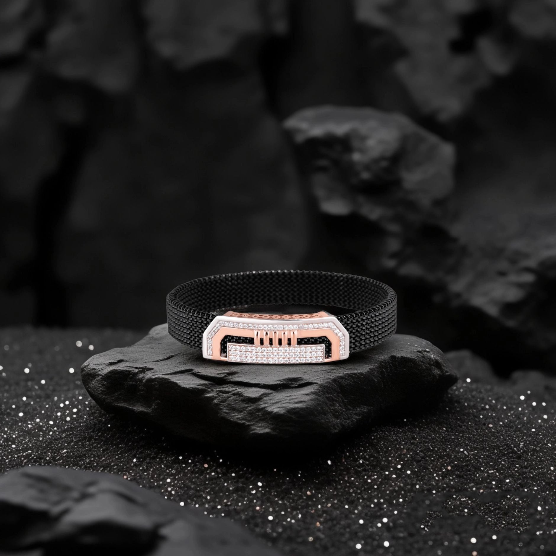 Black bracelet with a rose gold clasp on a dark stone surface