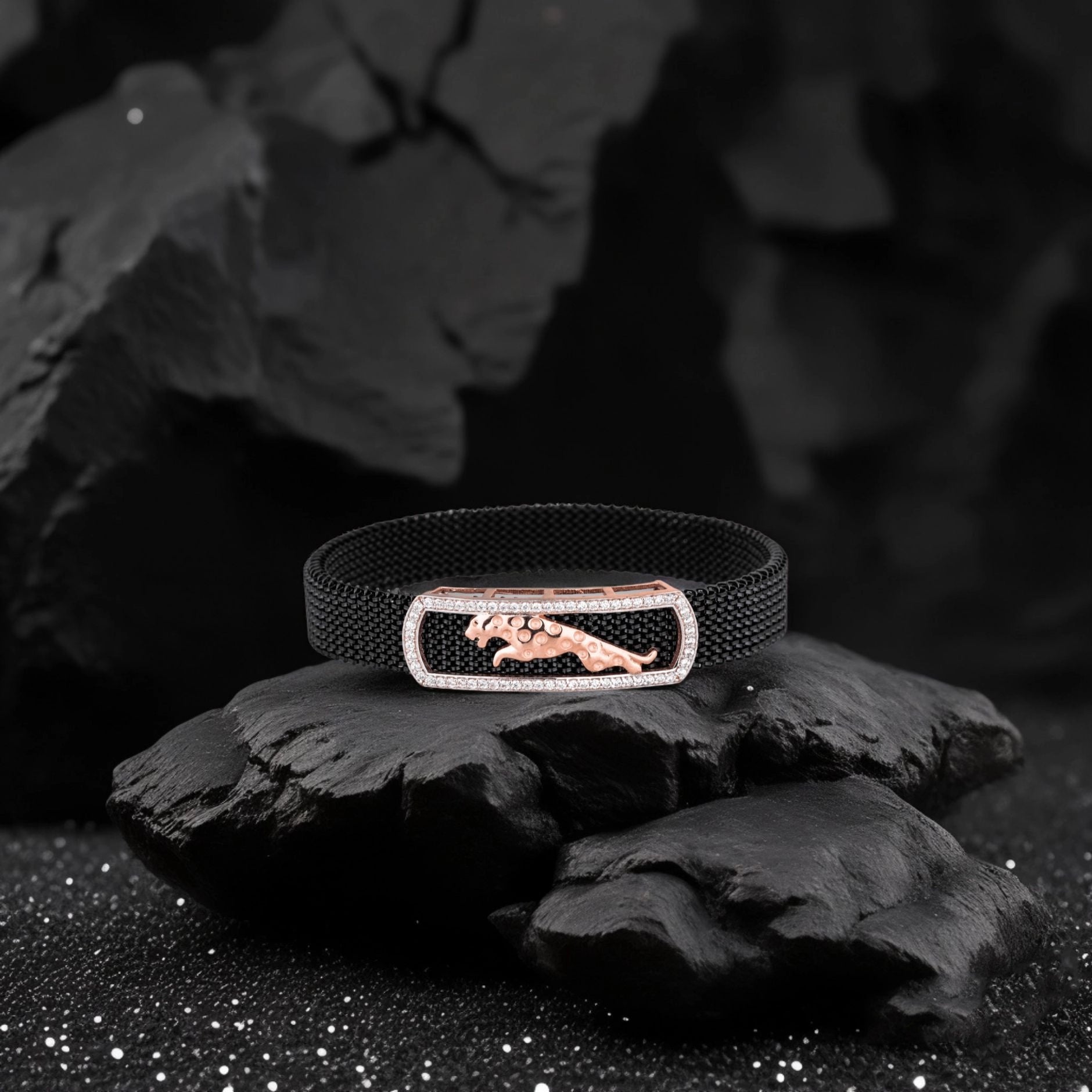 Black bracelet with a rose gold clasp featuring a panther design on a dark background.