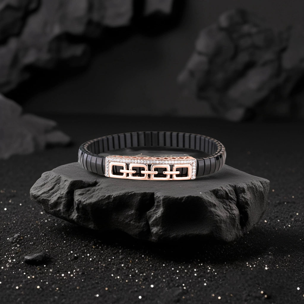 Black bracelet with a geometric design on a dark stone surface