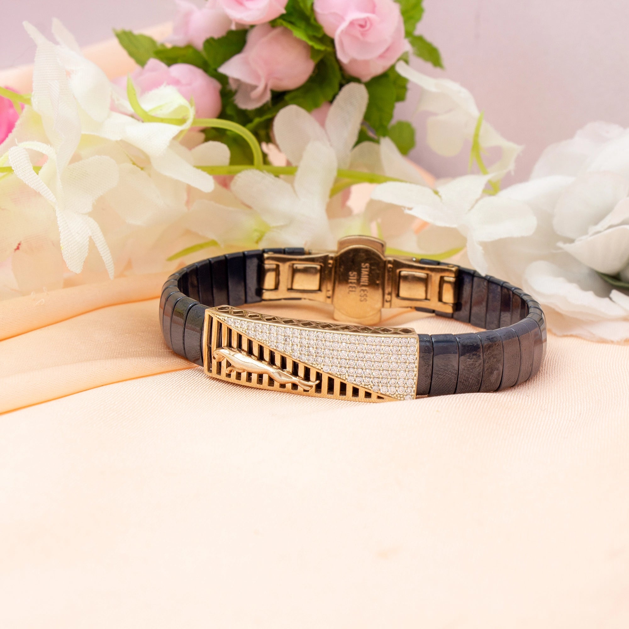 Luxury bracelet with gold and black design on a floral background