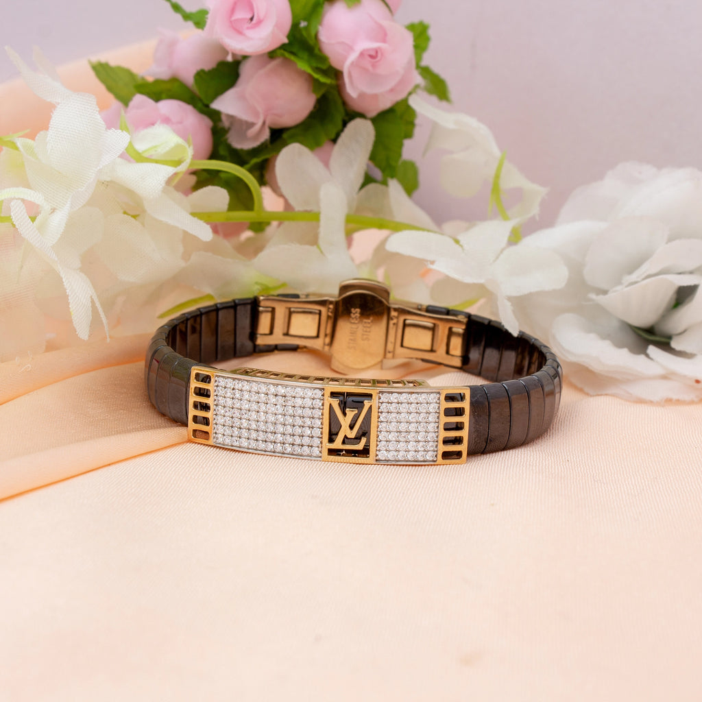 Luxury bracelet with brand logo on a pink surface with flowers