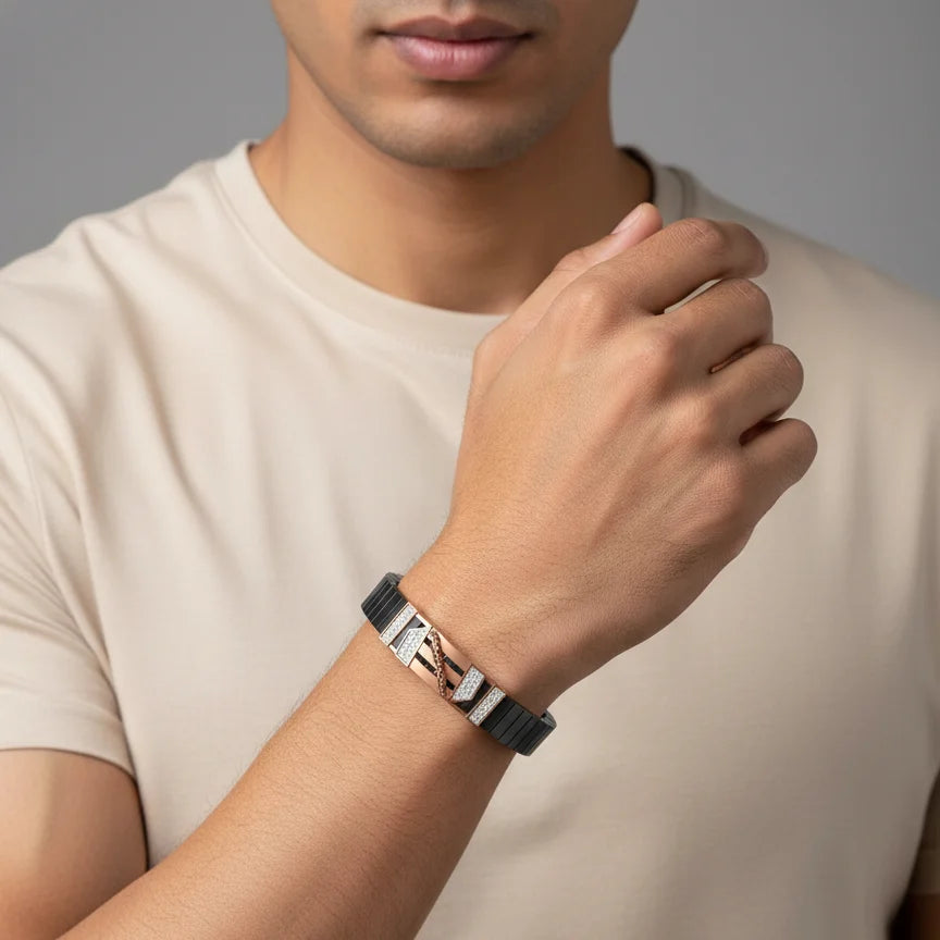 Man wearing a bracelet on his wrist with a neutral background